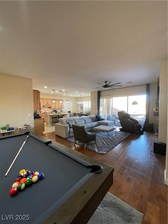 game room with dark hardwood / wood-style floors and ceiling fan