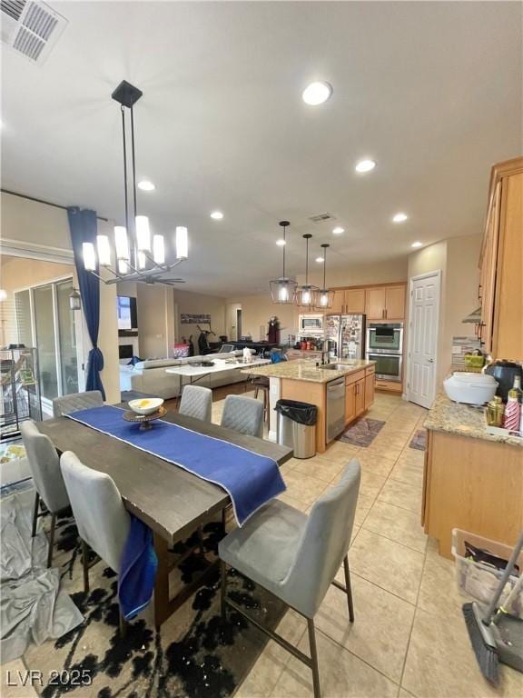 tiled dining room featuring a chandelier