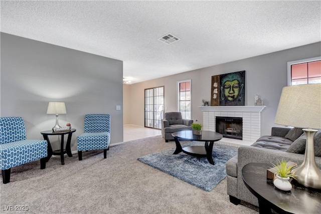 living room with a textured ceiling, carpet, and a fireplace