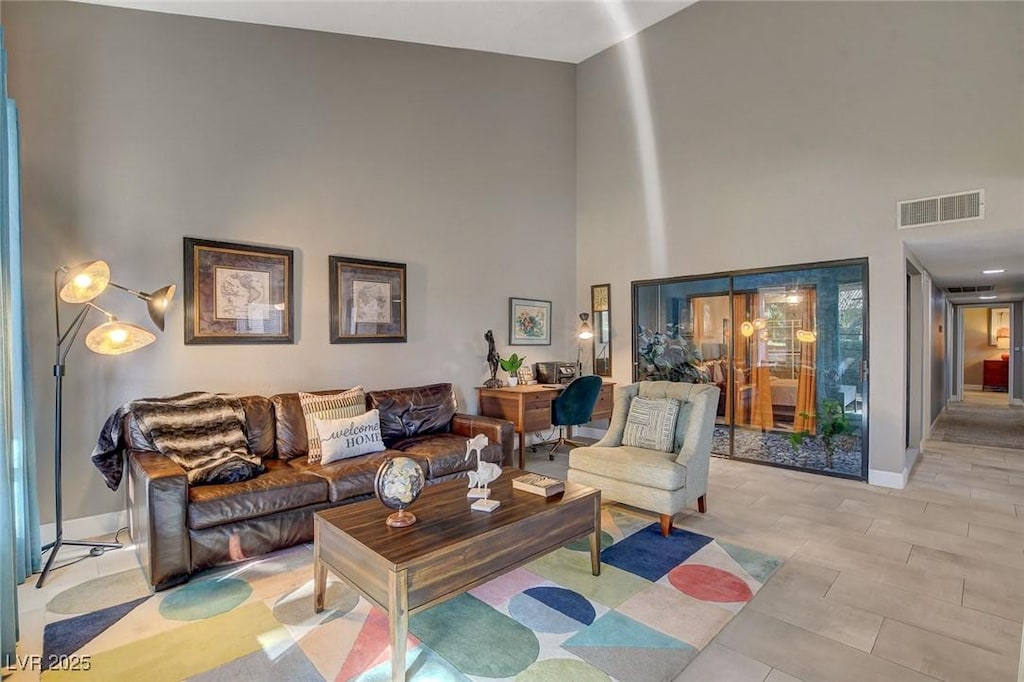 living room with a towering ceiling