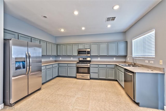 kitchen featuring sink, light tile patterned flooring, and appliances with stainless steel finishes