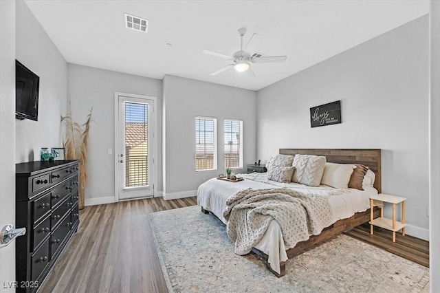 bedroom with hardwood / wood-style flooring, ceiling fan, and access to outside