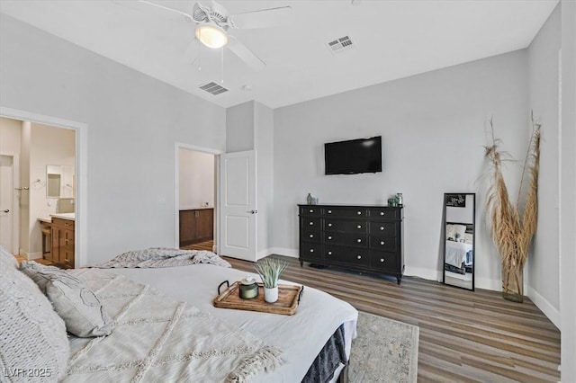 bedroom featuring ceiling fan, hardwood / wood-style floors, and ensuite bath