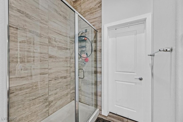 bathroom featuring a shower with door