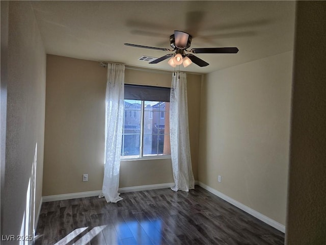 spare room featuring ceiling fan and dark hardwood / wood-style flooring