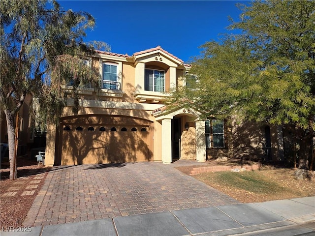 mediterranean / spanish home with a garage