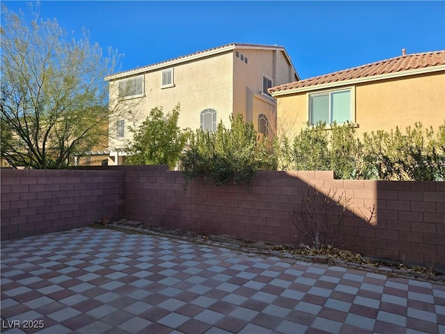 view of property exterior with a patio area