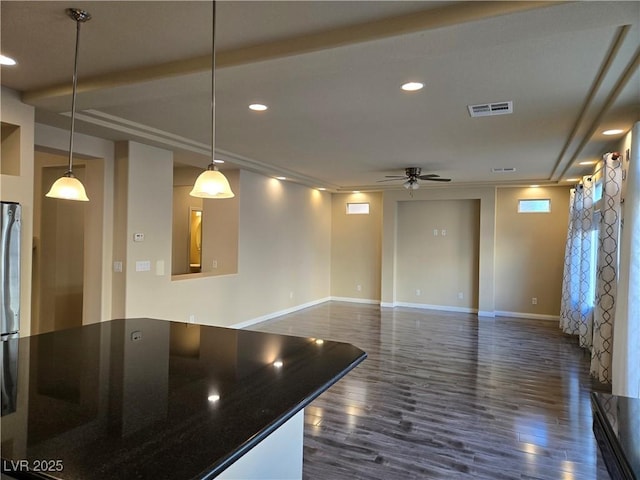 unfurnished living room featuring ceiling fan and dark hardwood / wood-style flooring