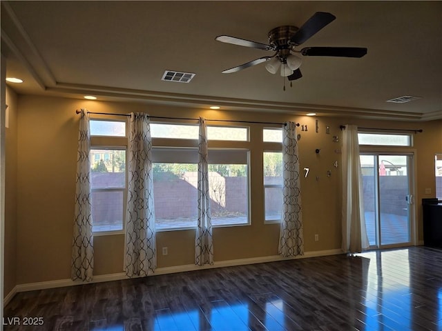 spare room with ceiling fan, dark hardwood / wood-style flooring, and a wealth of natural light