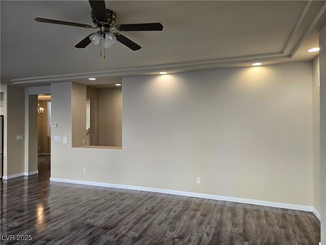 spare room featuring ceiling fan and dark wood-type flooring