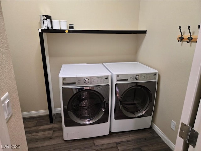 clothes washing area featuring dark wood-type flooring and washer and dryer