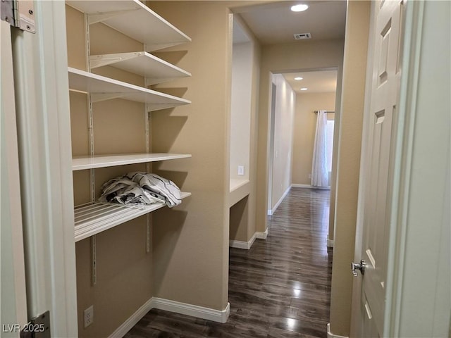 hallway with dark hardwood / wood-style floors