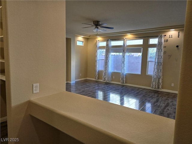 unfurnished room with ceiling fan, dark wood-type flooring, and crown molding