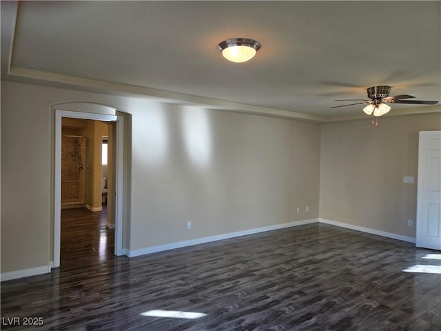 unfurnished room with ceiling fan and dark hardwood / wood-style flooring