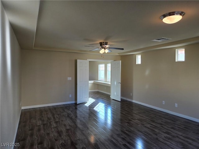 empty room featuring ceiling fan and dark hardwood / wood-style floors