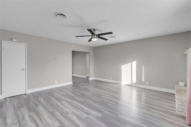 empty room featuring ceiling fan and light wood-type flooring