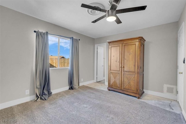 unfurnished bedroom with ceiling fan and light colored carpet