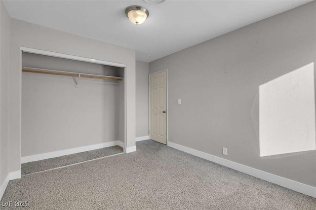 unfurnished bedroom featuring carpet and a closet