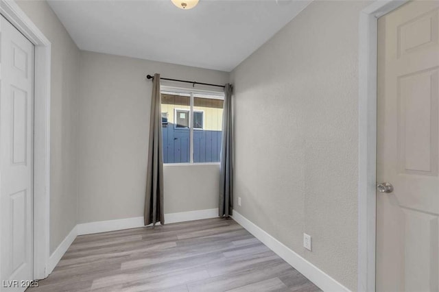 unfurnished bedroom featuring light wood-type flooring