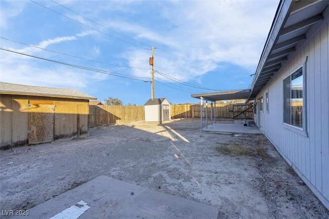 view of yard featuring a patio area and a shed