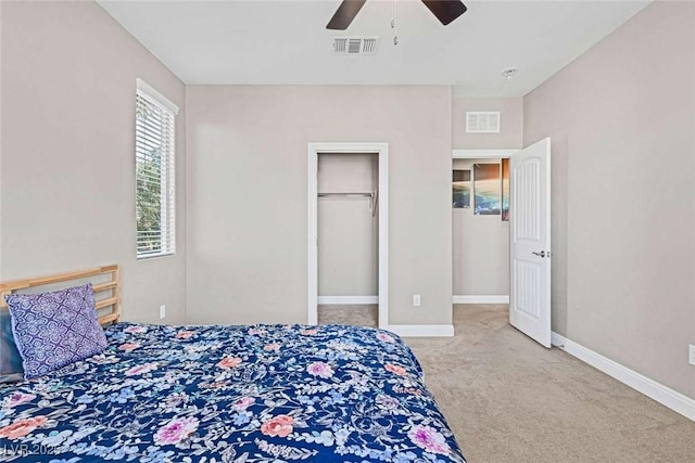 carpeted bedroom featuring ceiling fan and a closet