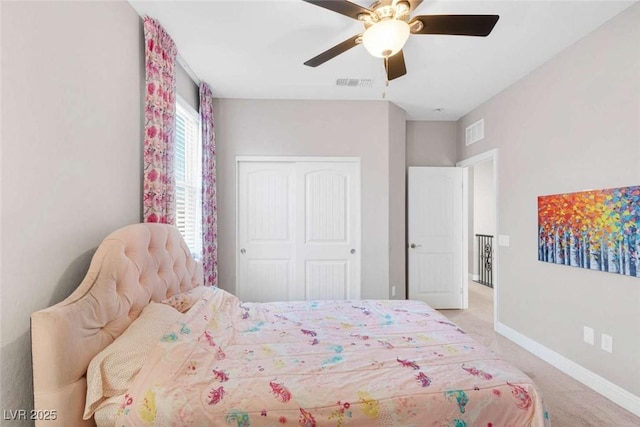 carpeted bedroom featuring ceiling fan and a closet