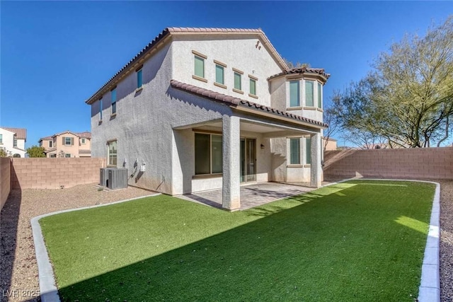 rear view of house featuring a patio area, central AC unit, and a lawn