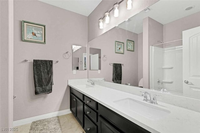 bathroom with  shower combination, tile patterned floors, and vanity