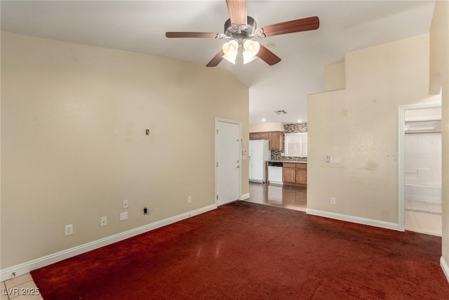 carpeted spare room with high vaulted ceiling and ceiling fan