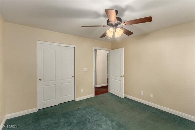 unfurnished bedroom with ceiling fan, a closet, and dark colored carpet