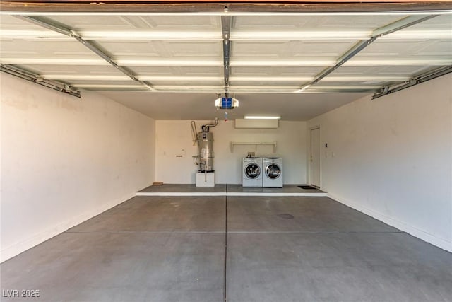 garage featuring a garage door opener, strapped water heater, and washer and clothes dryer