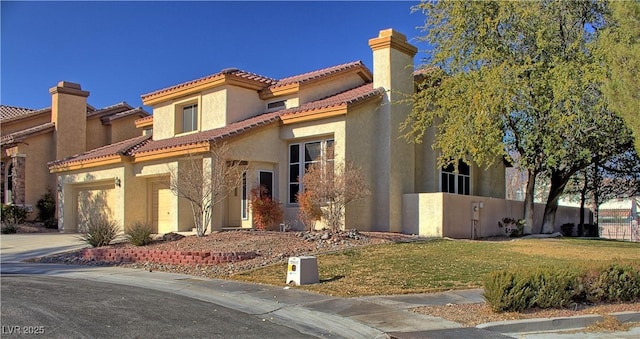 view of front of home featuring a front lawn and a garage