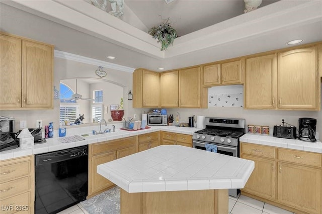 kitchen featuring light brown cabinetry, tile counters, a center island, and stainless steel appliances