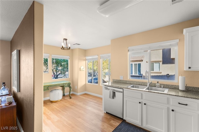 kitchen featuring white cabinetry, dishwasher, light hardwood / wood-style flooring, and sink