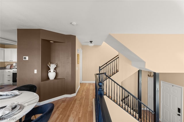 interior space featuring light hardwood / wood-style floors and white cabinets