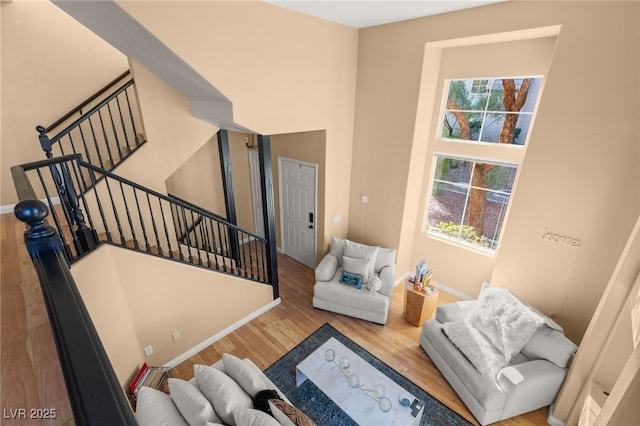 staircase with plenty of natural light and hardwood / wood-style floors