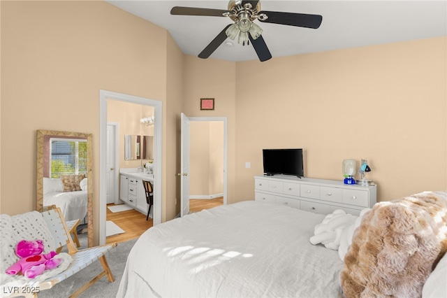 bedroom featuring ensuite bath, ceiling fan, and light hardwood / wood-style floors