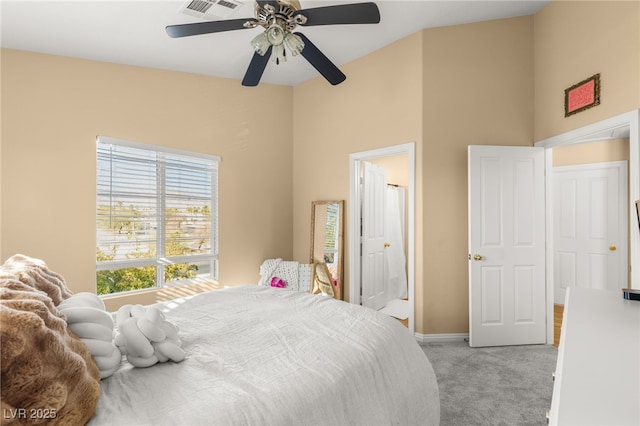 carpeted bedroom featuring ceiling fan and connected bathroom