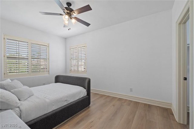 bedroom with ceiling fan and light hardwood / wood-style floors