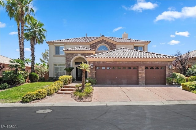 mediterranean / spanish home with a garage