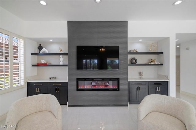 living room with a wealth of natural light and a large fireplace