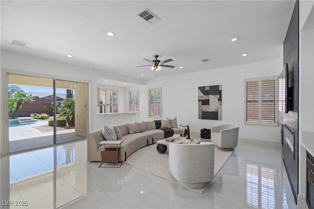 tiled living room featuring ceiling fan