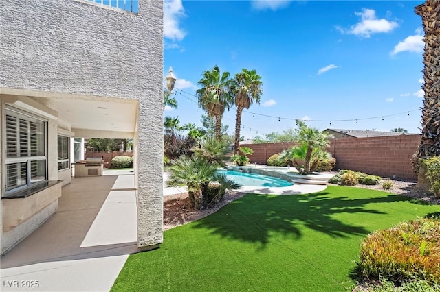 view of yard featuring a fenced in pool and a patio