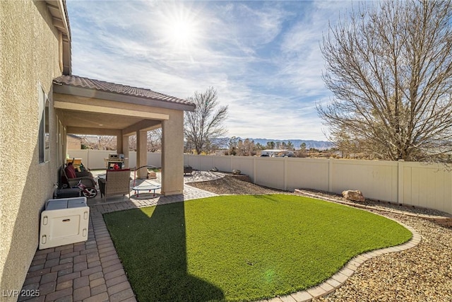 view of yard featuring a mountain view and a patio