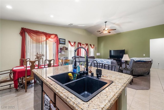 kitchen featuring a center island, sink, black dishwasher, and plenty of natural light