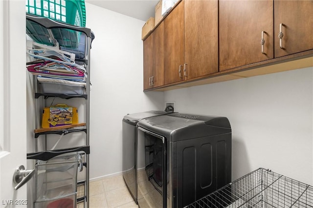 washroom featuring cabinets and washer and dryer