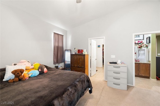 carpeted bedroom featuring ensuite bathroom and vaulted ceiling