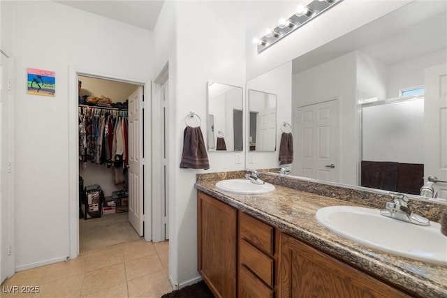 bathroom with tile patterned floors, vanity, and a shower with shower door