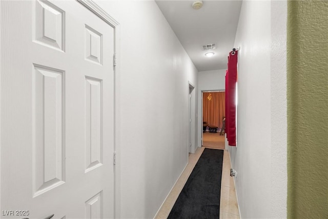 hallway featuring light tile patterned flooring