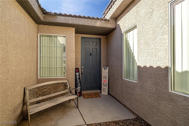 entrance to property featuring a patio area